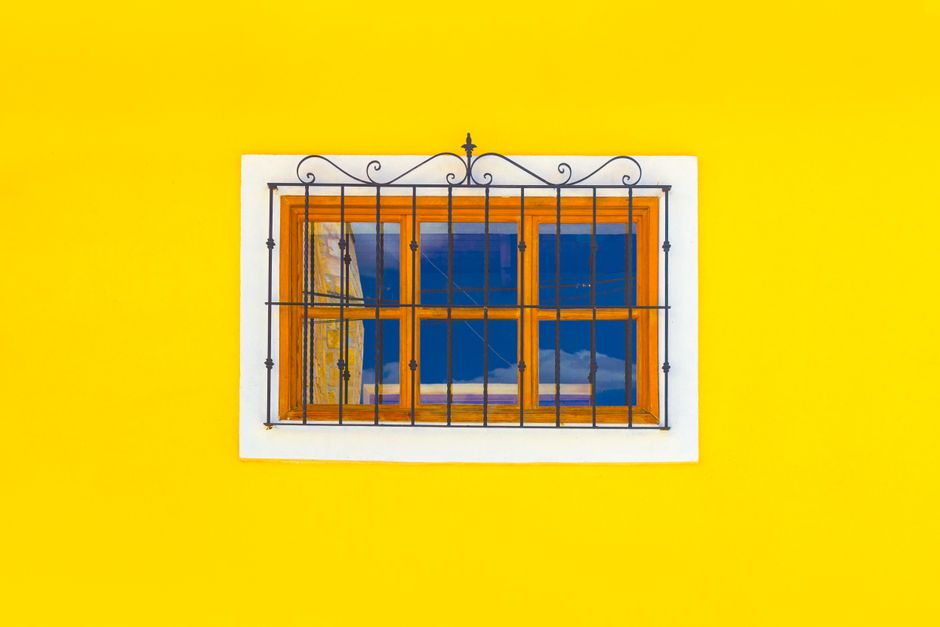 Window with a wooden frame on a painted wall