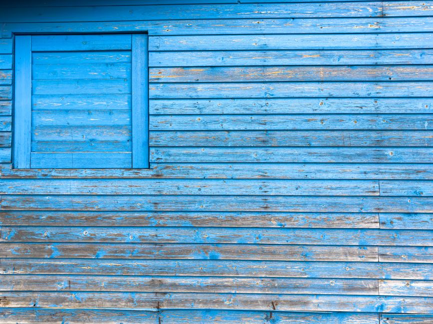 Painted wooden wall with peeling paint