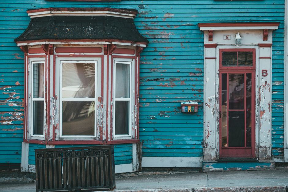 Painted house wall with a window and door