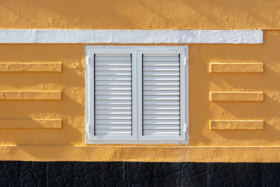 Painted wall with white shutters