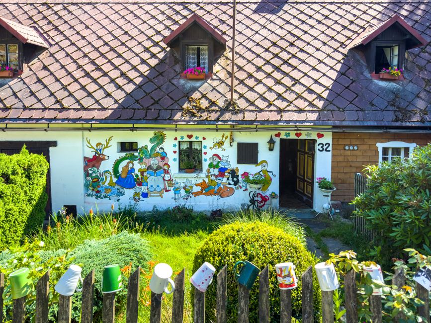 Painted cottage exterior with a front yard
